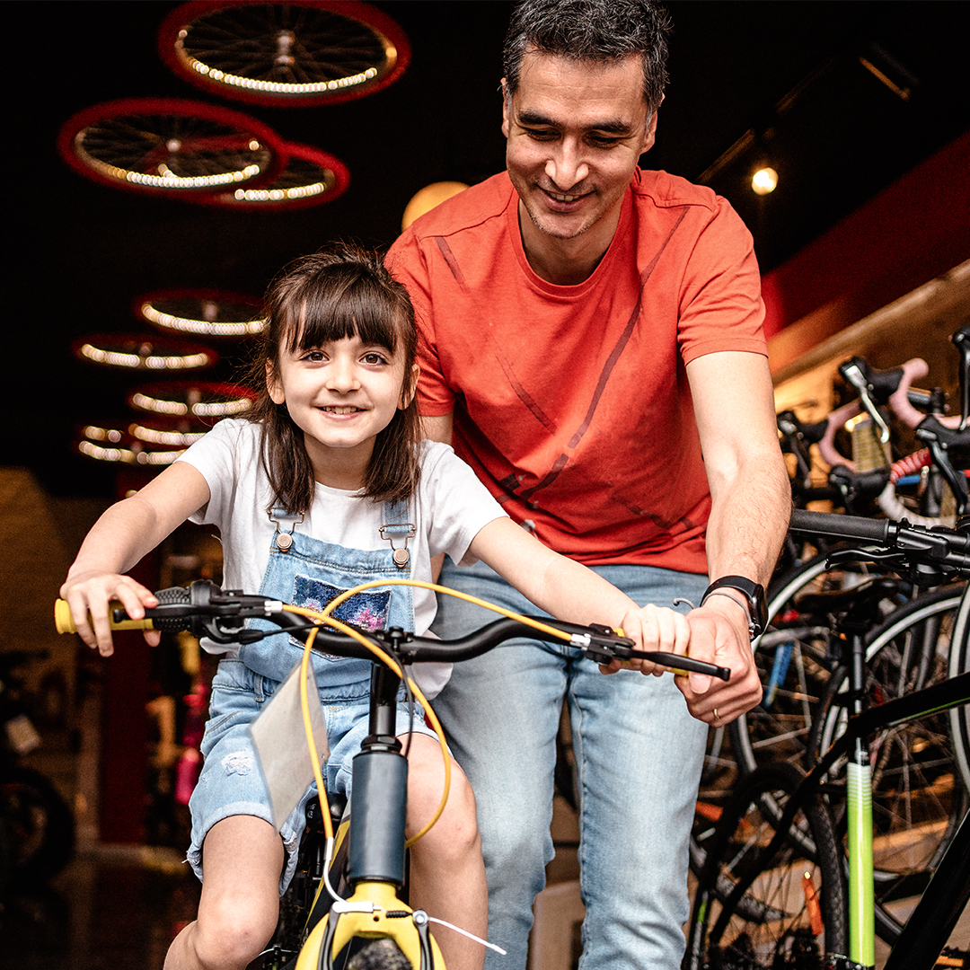child on bike with adult
