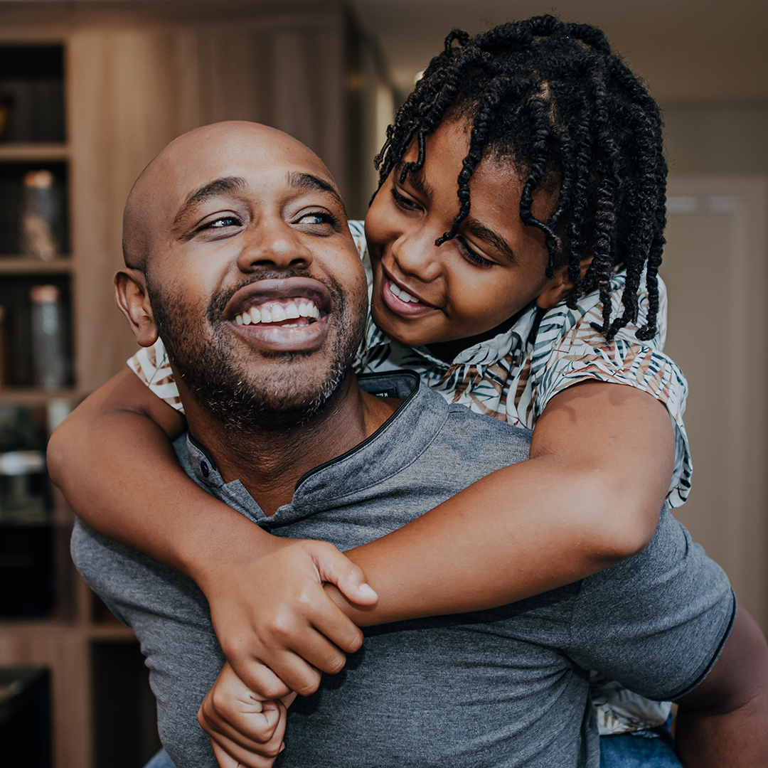 Man with child on back