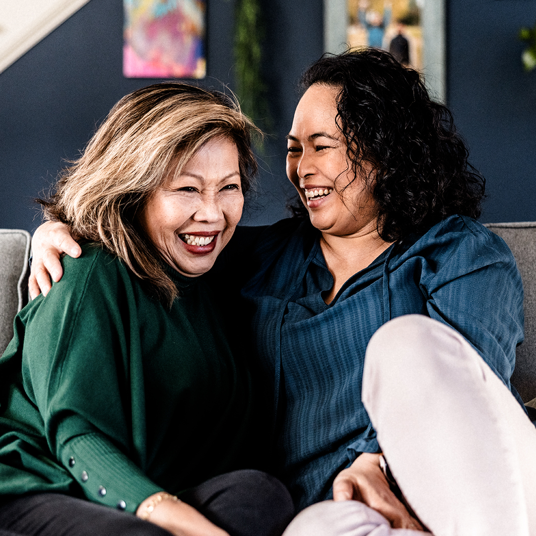 Mom, daughter embrace on couch