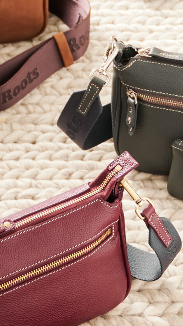 multiple Roots brand purses on rug