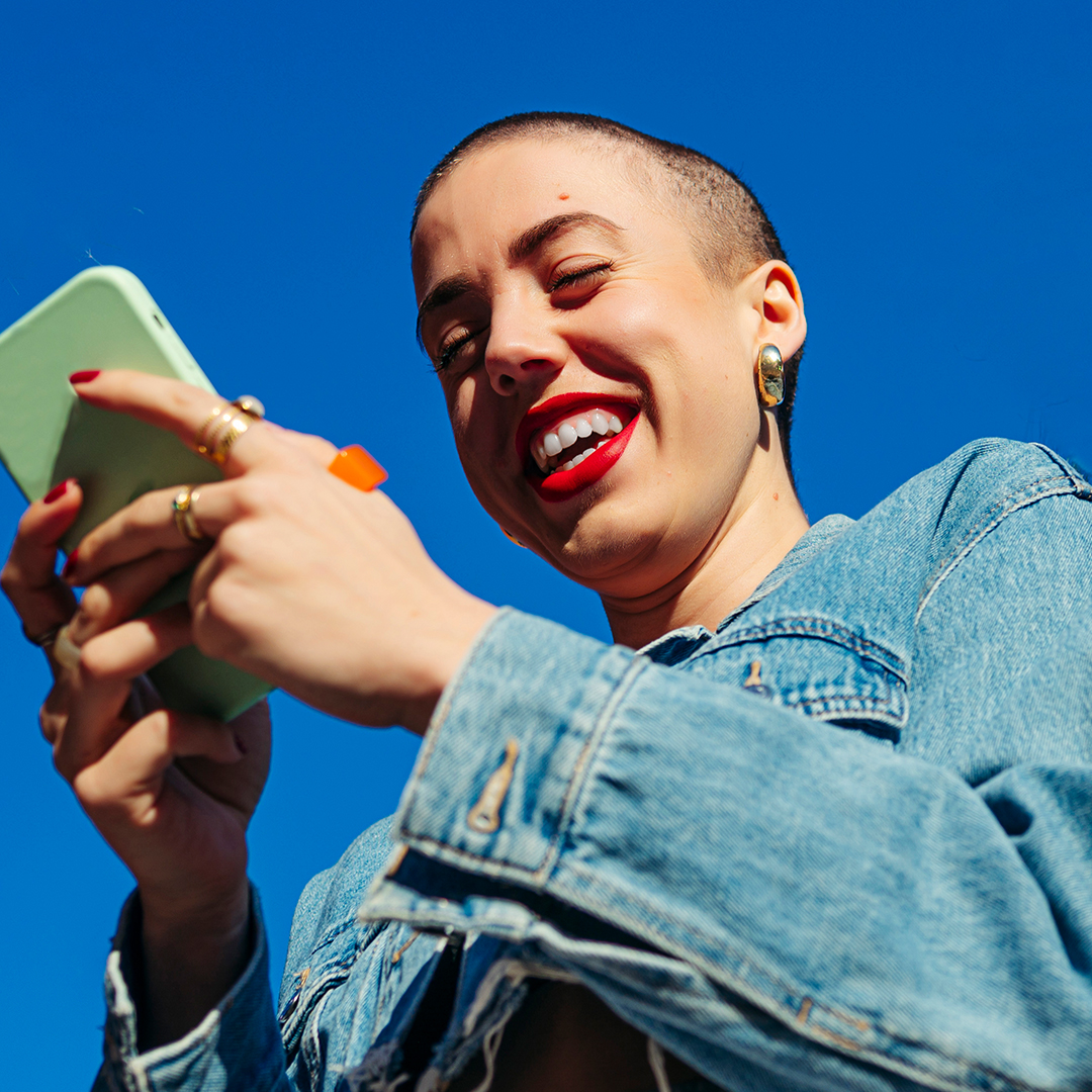 Bald woman using cell phone