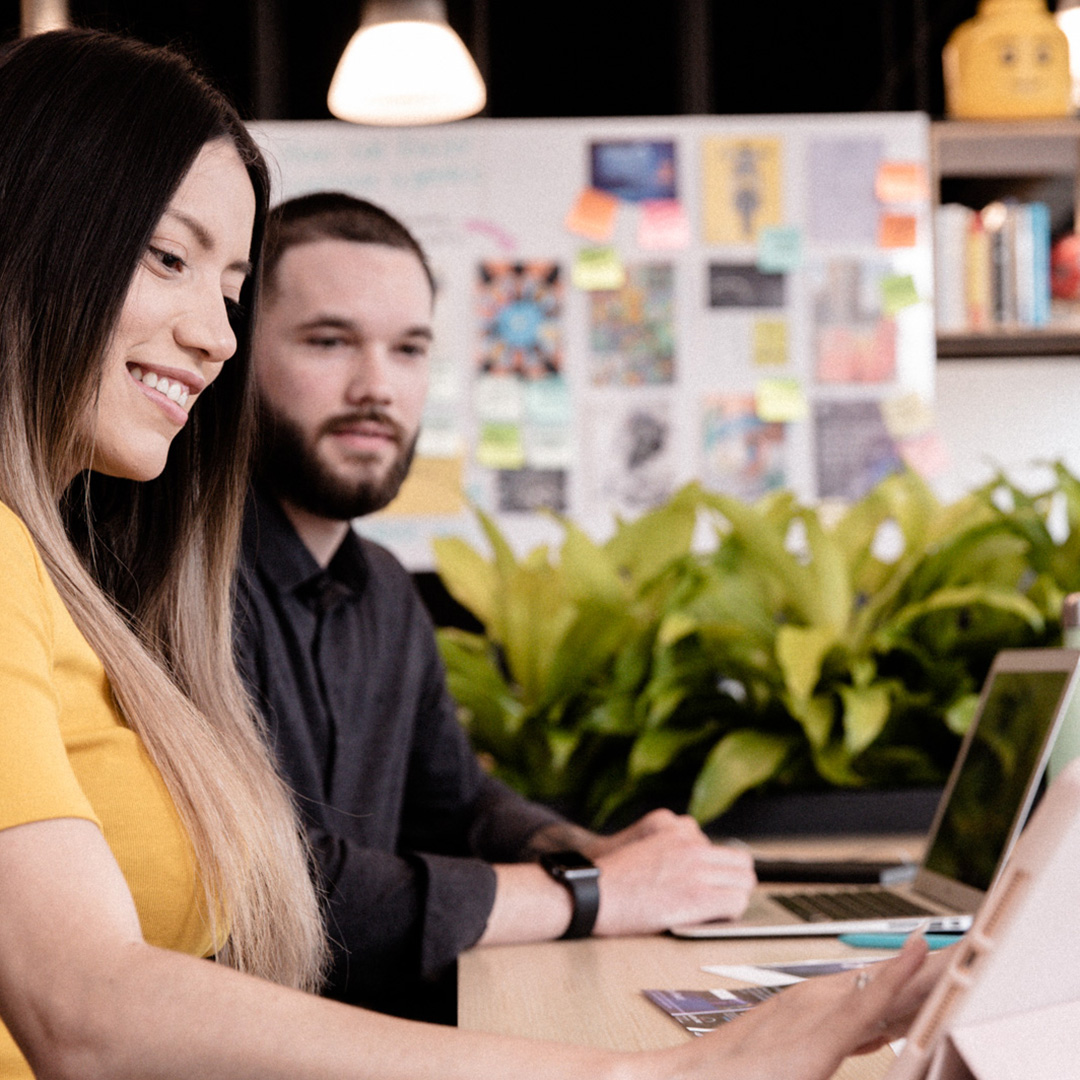 Man & woman working on laptop