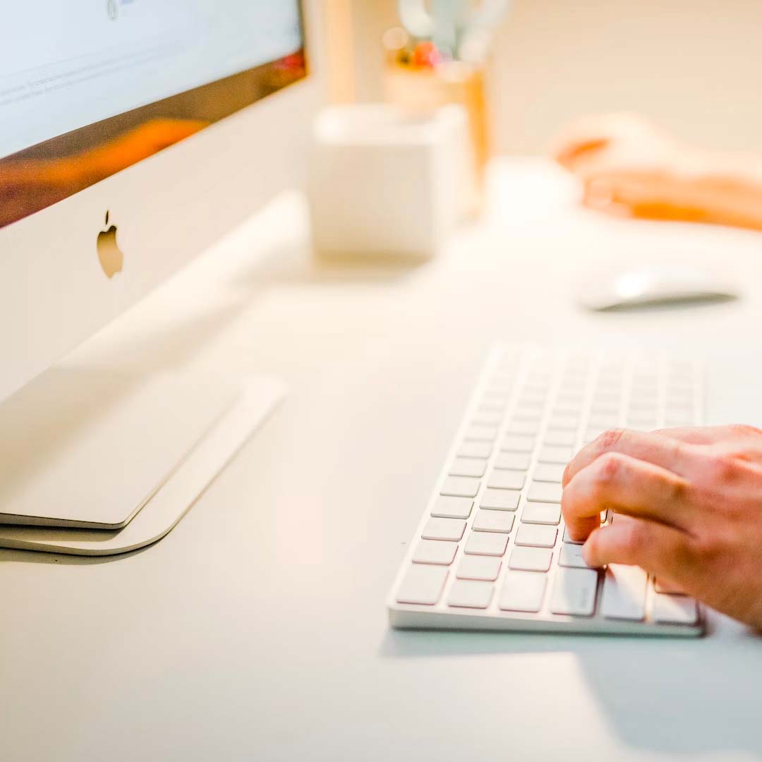 Person typing on keyboard