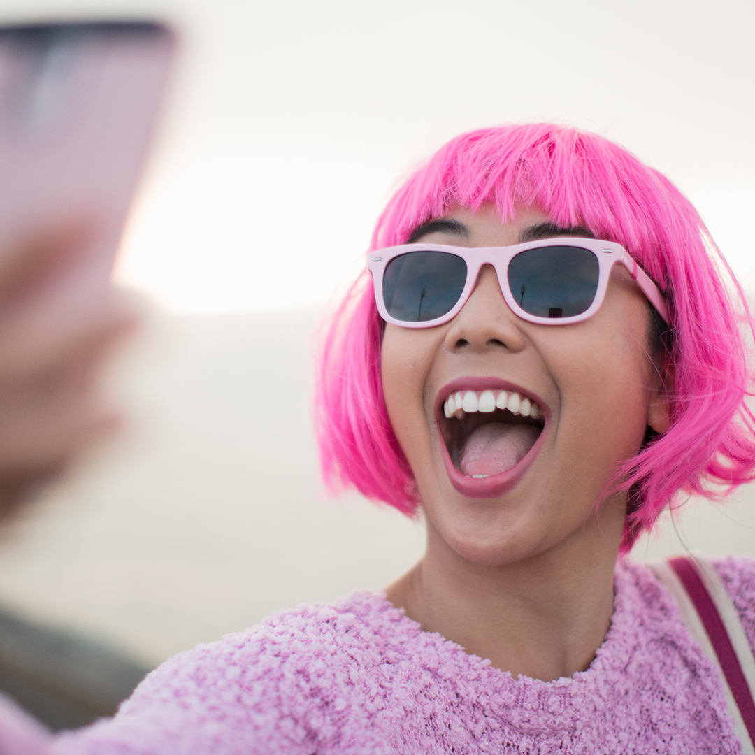 Pink-haired woman smiling