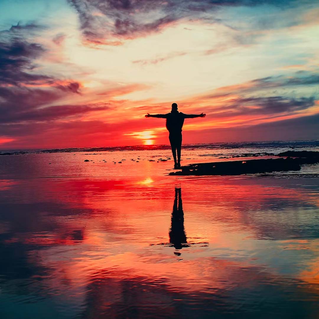 Person on beach at sunset