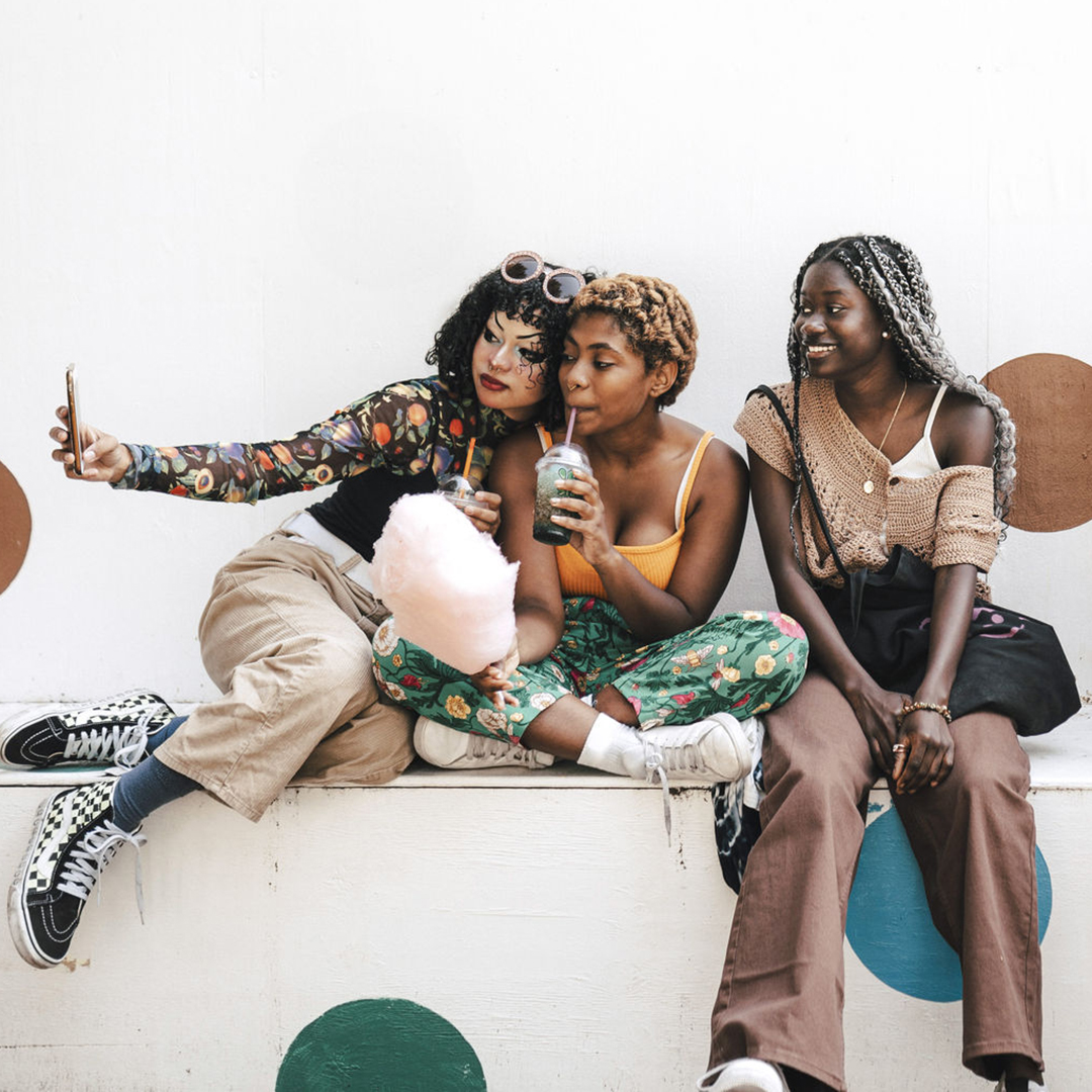Group of women take selfies
