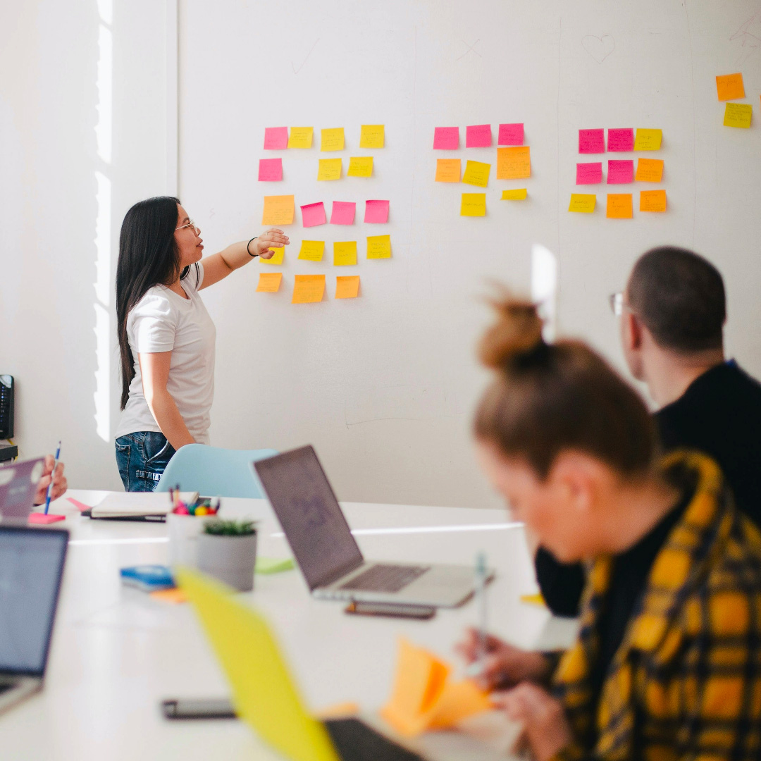 team meeting with sticky notes on wall