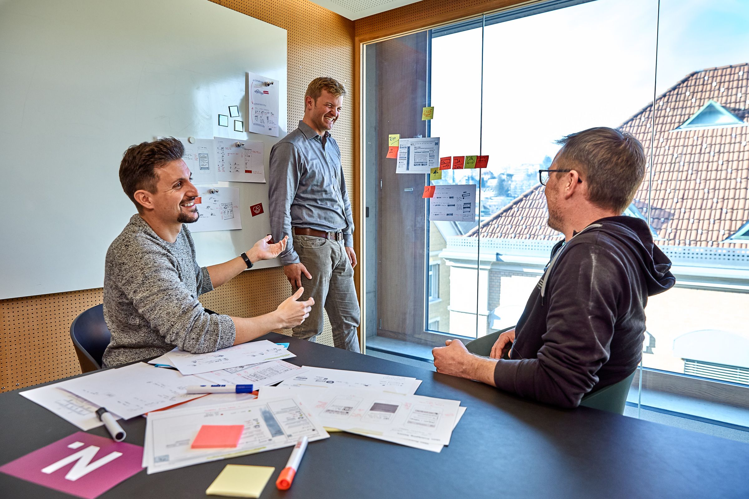 Three young managers from Merkle discussing customer experience