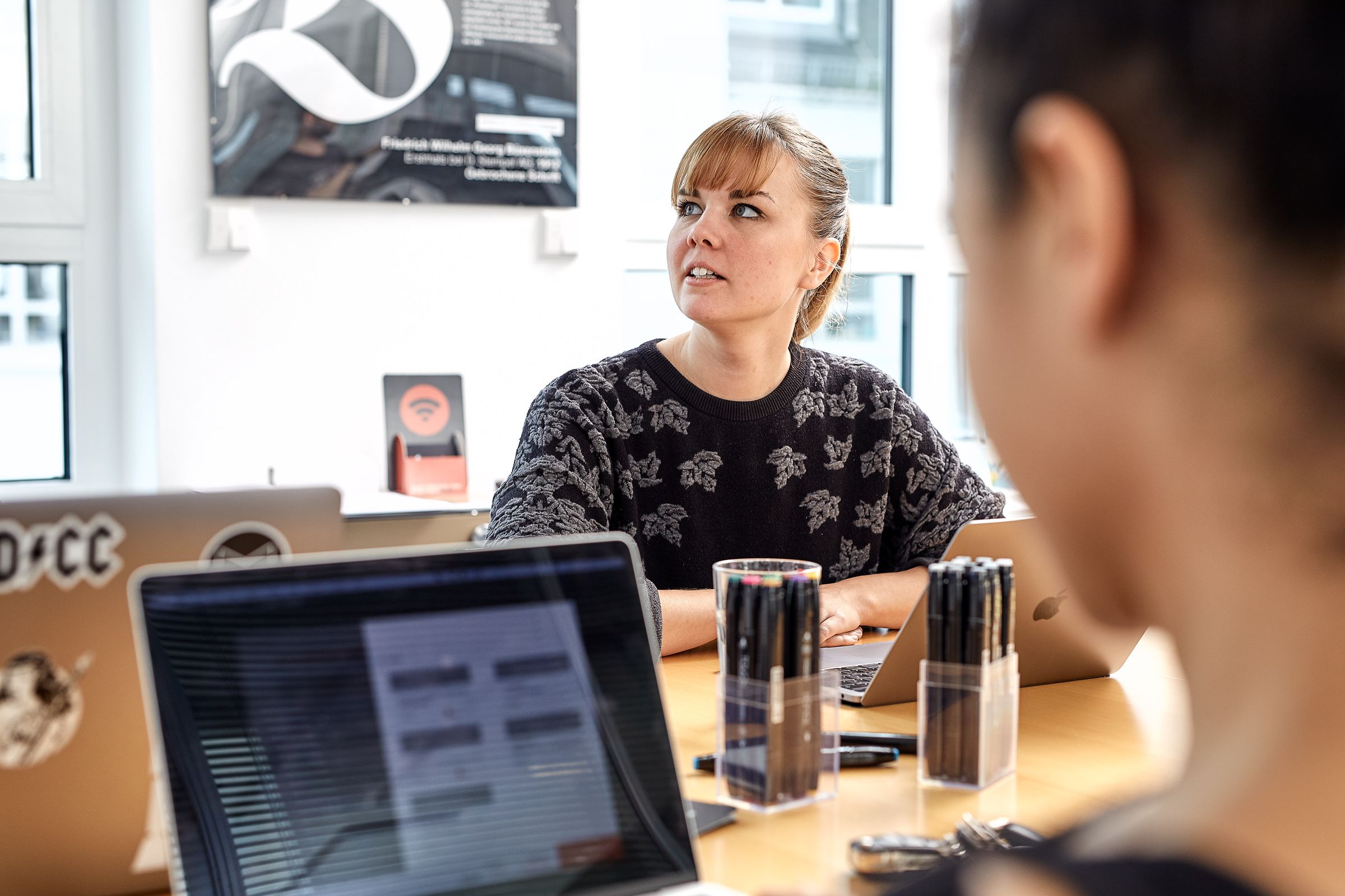 Woman is thinking about User Experience in meeting