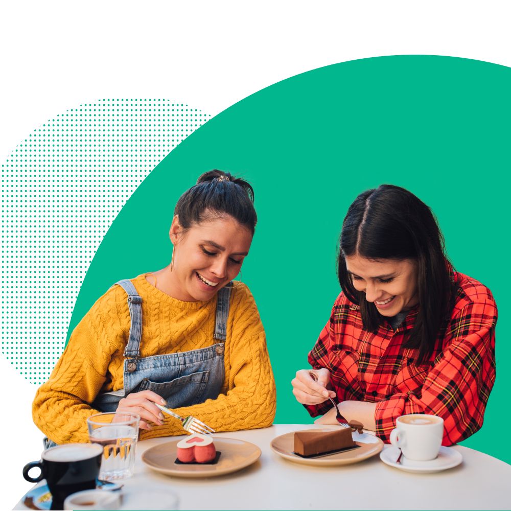 Two women eating cake