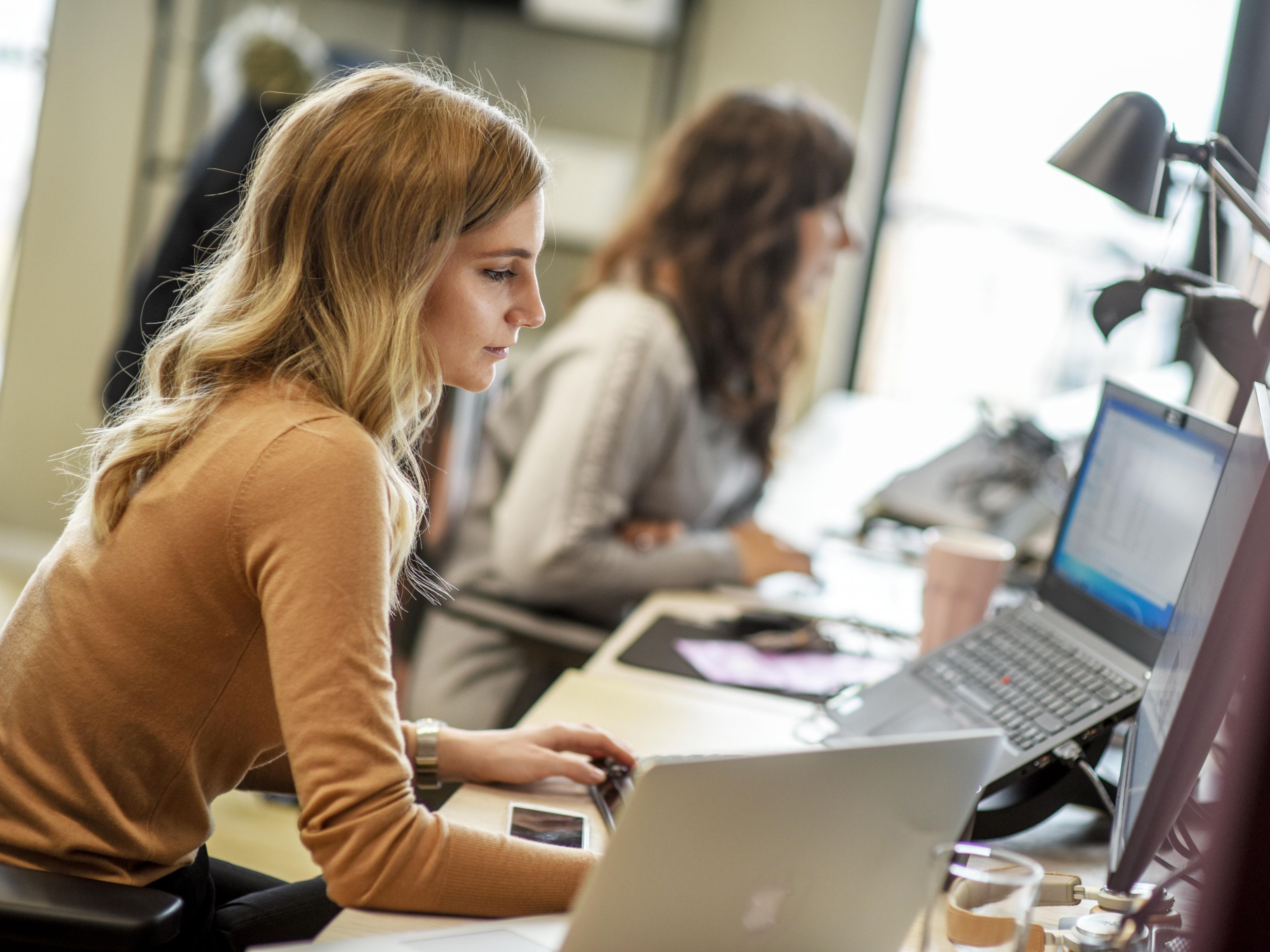 Two women working on computer at Merkle