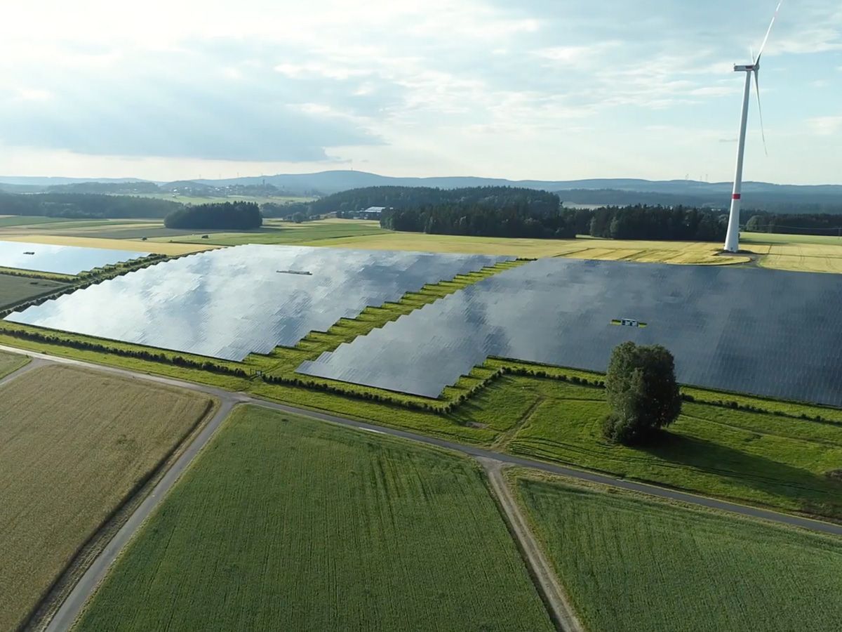 Picture showing solar power and wind turbines