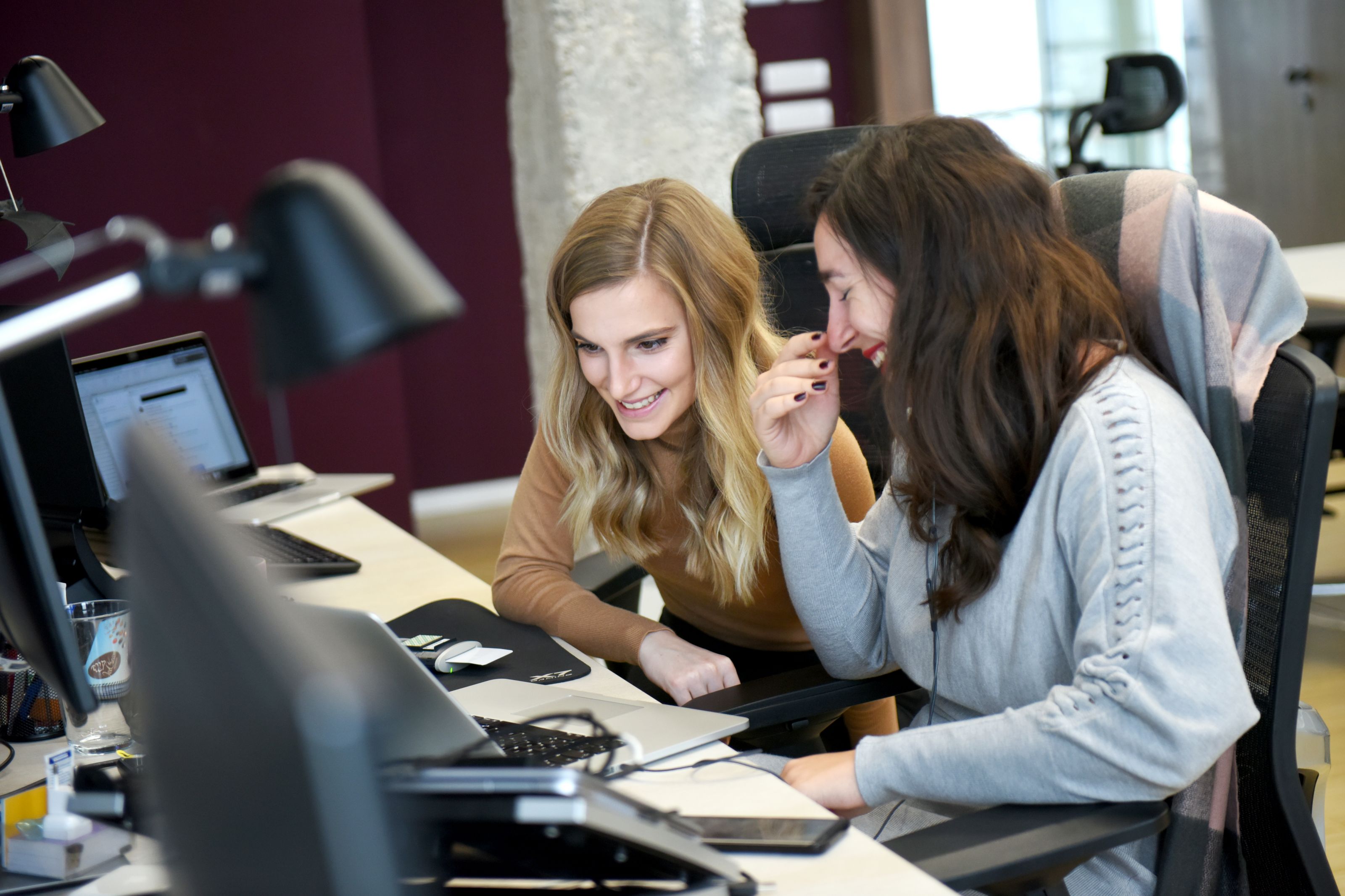 Two colleagues having fun at work 